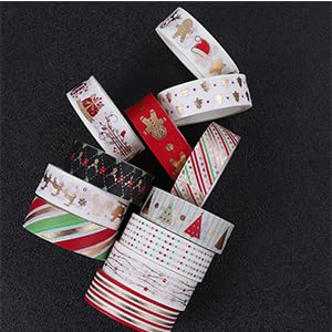 Assortment of white and red decorative washi tape rolls with various patterns and designs.